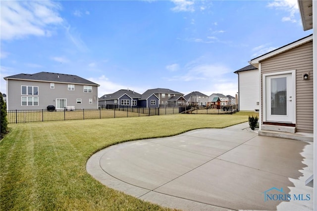 view of yard featuring a patio area, a fenced backyard, and a residential view