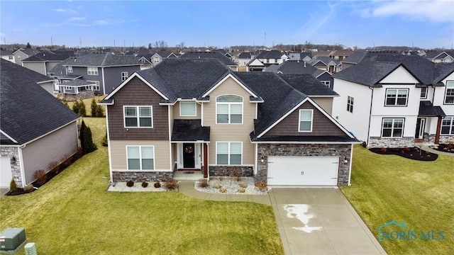 view of front facade with driveway, a garage, a residential view, and a front yard