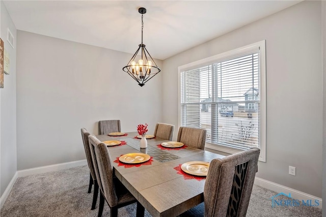 dining area featuring an inviting chandelier, carpet, visible vents, and baseboards