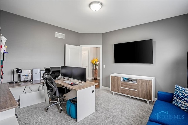 office space featuring carpet, visible vents, and baseboards