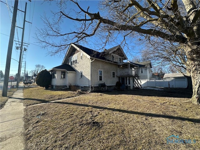 view of side of home featuring fence