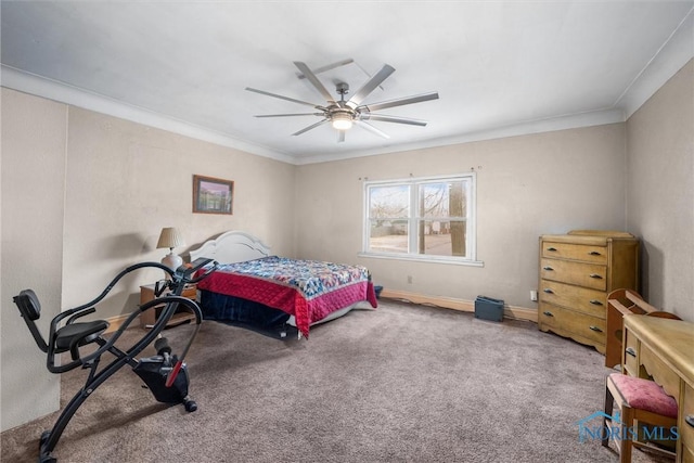 carpeted bedroom with ornamental molding, ceiling fan, and baseboards