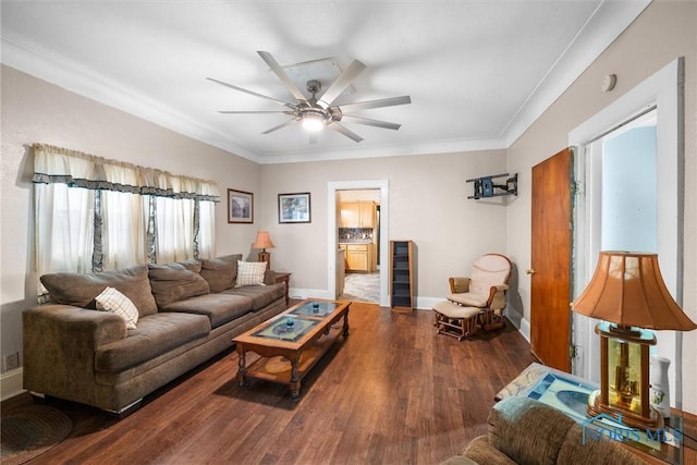 living area with ceiling fan, crown molding, baseboards, and wood finished floors