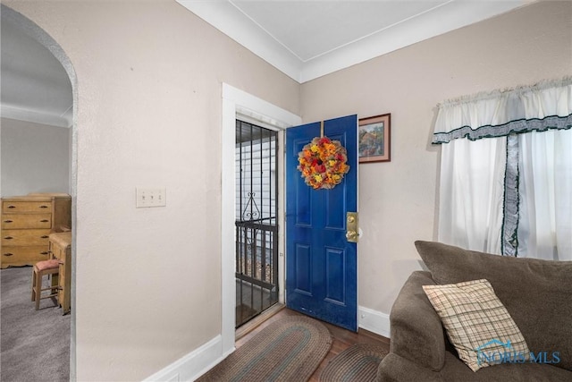 entrance foyer with arched walkways and baseboards