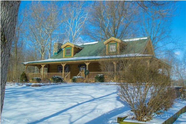 log cabin with a porch and a chimney