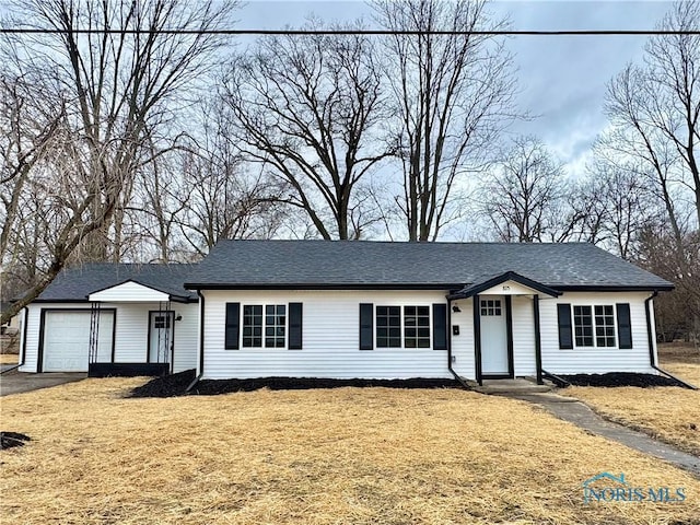 single story home with an attached garage, aphalt driveway, a front lawn, and roof with shingles