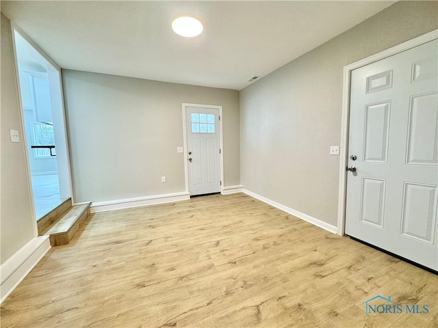 entryway with light wood-type flooring and baseboards