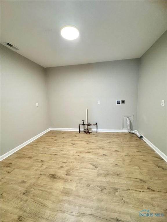 laundry room featuring laundry area, baseboards, visible vents, and wood finished floors