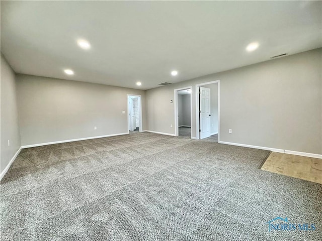 unfurnished room featuring carpet floors, visible vents, baseboards, and recessed lighting