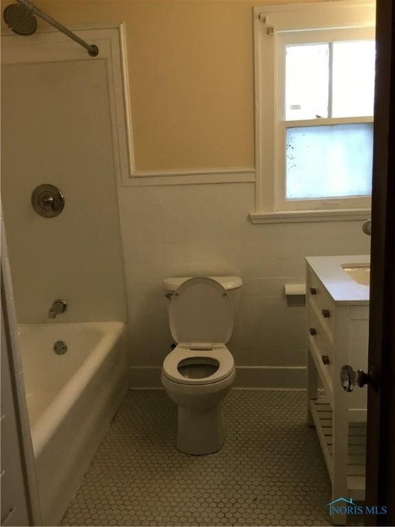 bathroom with toilet, tile patterned floors, tub / shower combination, and vanity