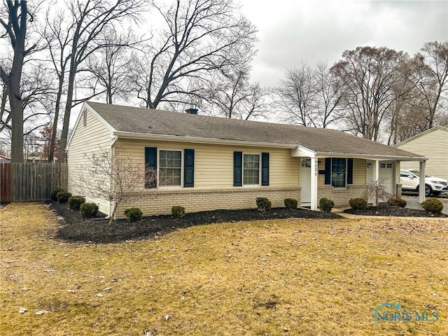 single story home featuring a garage, fence, and brick siding