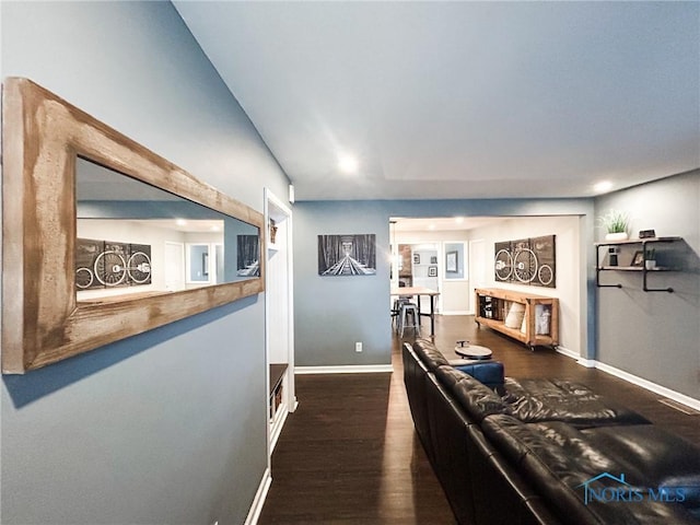 living area with a fireplace, wood finished floors, and baseboards