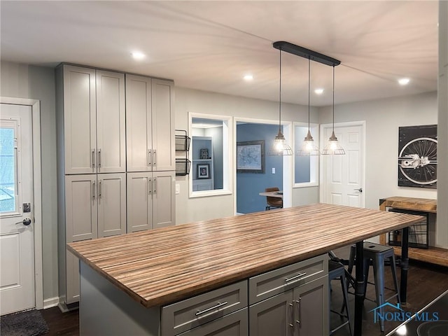 kitchen with recessed lighting, dark wood-style floors, butcher block counters, and gray cabinetry