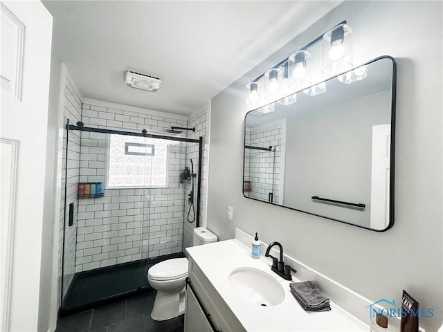 bathroom with vanity, tile patterned flooring, a shower stall, and toilet