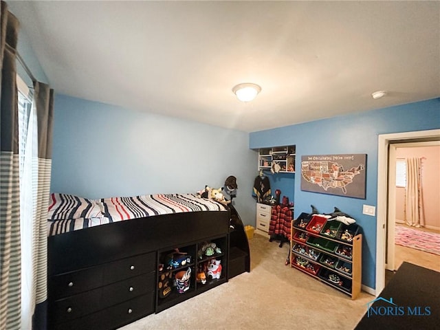 carpeted bedroom featuring multiple windows