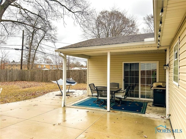 view of patio / terrace featuring a grill and fence