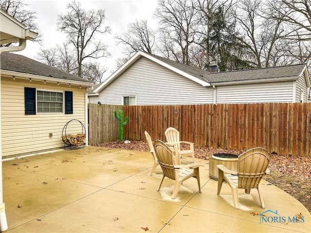 view of patio / terrace featuring an outdoor fire pit and fence