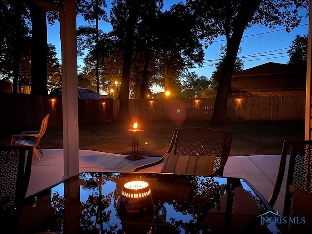 view of patio featuring an outdoor fire pit and a fenced backyard