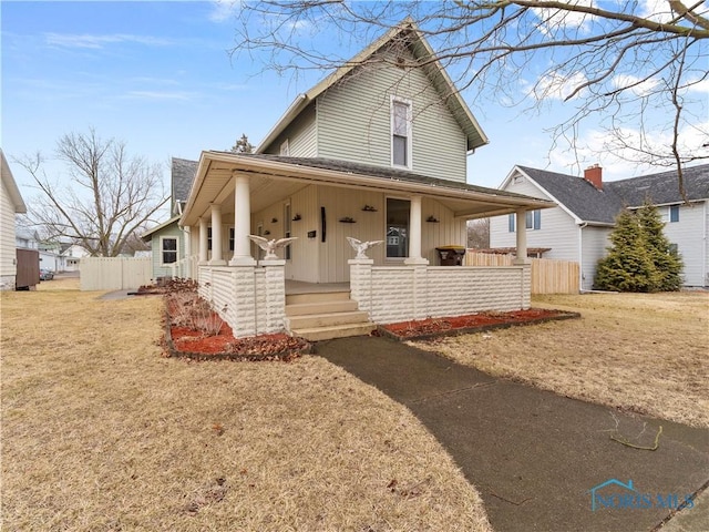 farmhouse inspired home featuring fence and a porch