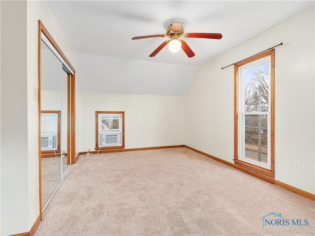 additional living space featuring carpet floors, lofted ceiling, cooling unit, and baseboards