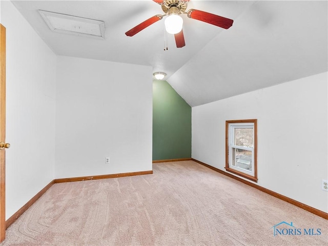 additional living space featuring attic access, baseboards, a ceiling fan, lofted ceiling, and carpet floors