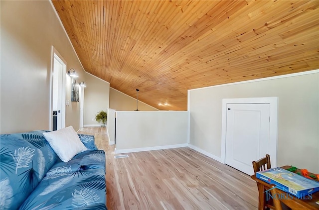 interior space featuring lofted ceiling, wood ceiling, wood finished floors, and baseboards