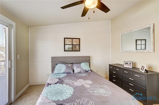 bedroom featuring light colored carpet, baseboards, ceiling fan, and vaulted ceiling