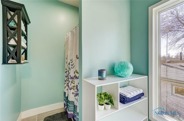 full bath with tile patterned flooring and baseboards