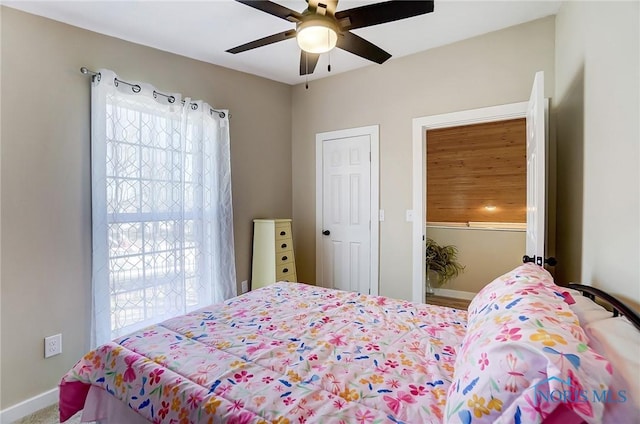 bedroom featuring multiple windows and ceiling fan