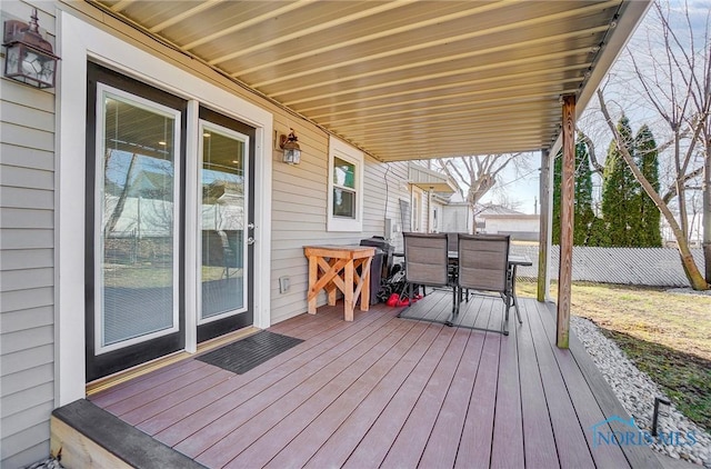 deck featuring outdoor dining space and fence