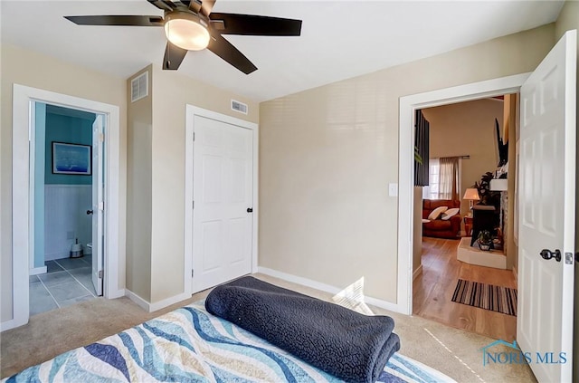 bedroom with visible vents, carpet flooring, baseboards, and a ceiling fan