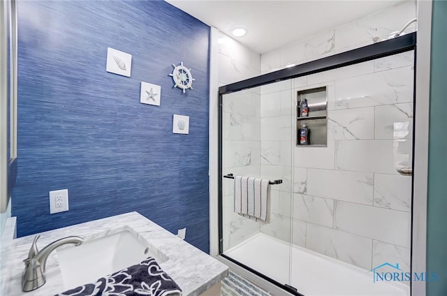 bathroom featuring a sink and a shower stall