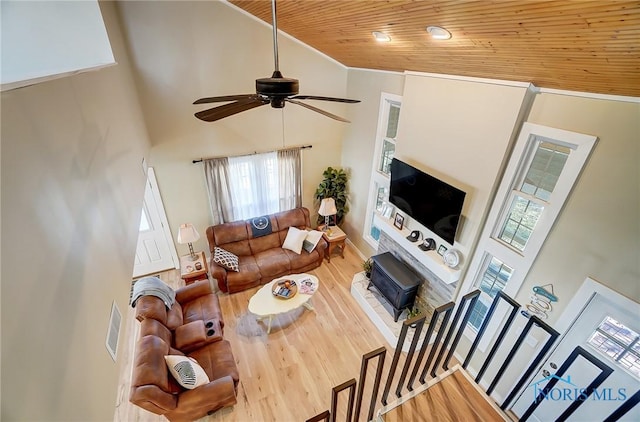 living area with wooden ceiling, high vaulted ceiling, crown molding, and wood finished floors