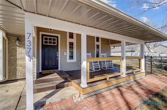 view of exterior entry featuring a porch