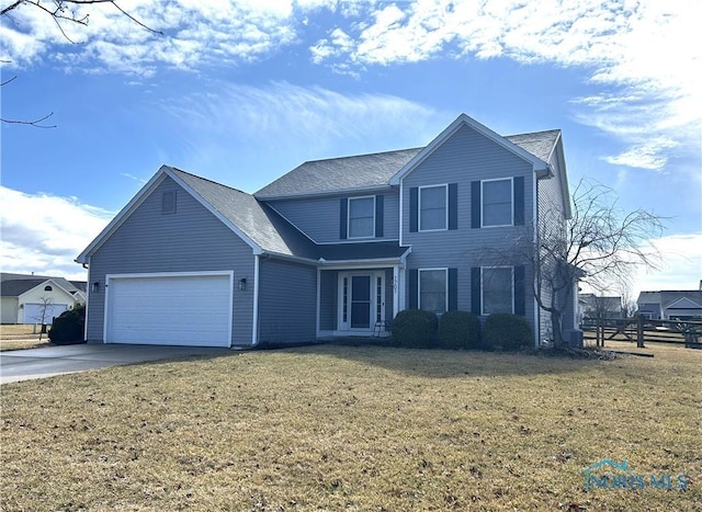 traditional-style home with driveway, an attached garage, fence, and a front lawn