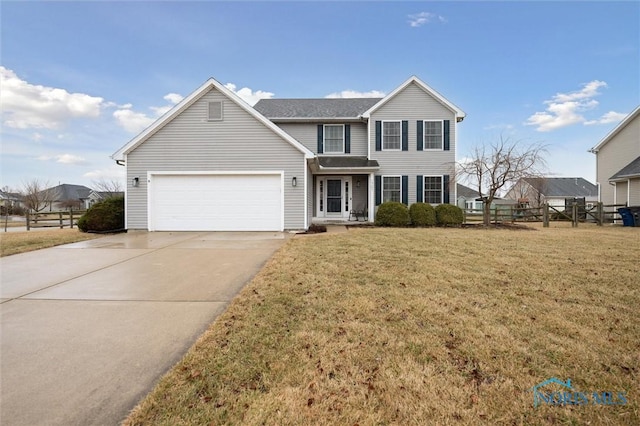 traditional home featuring a garage, driveway, a front lawn, and fence