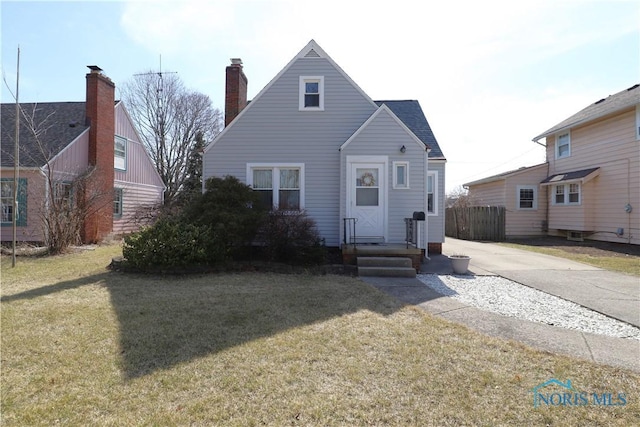 view of front of house with a front yard and a chimney