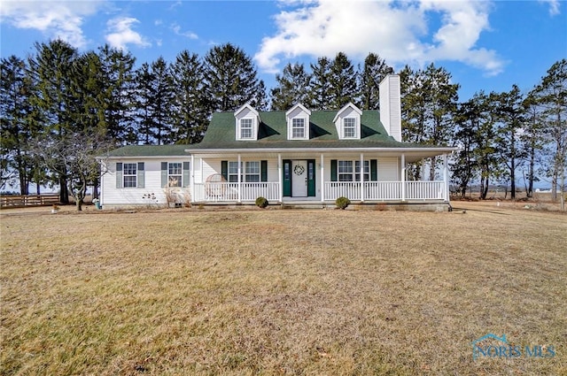 view of front of home featuring a porch, a chimney, and a front lawn