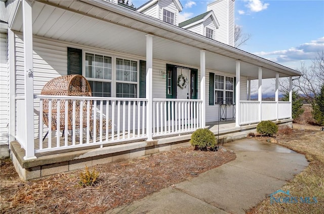 property entrance featuring a chimney and a porch