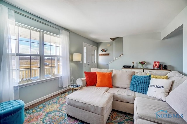 living area with baseboards and wood finished floors