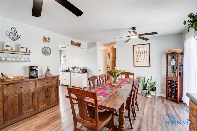 dining area with light wood-style floors, ceiling fan, and baseboards