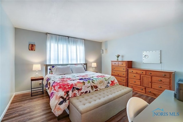 bedroom with baseboards and wood finished floors