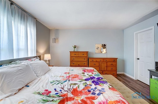 bedroom featuring wood finished floors and baseboards