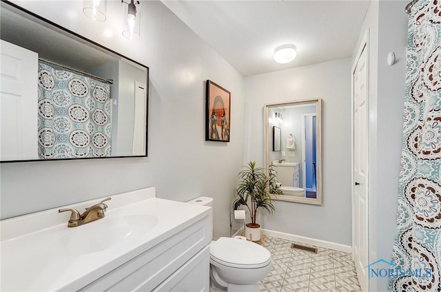 full bathroom featuring visible vents, toilet, vanity, baseboards, and tile patterned floors