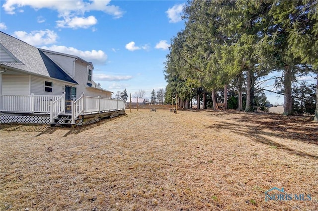 view of yard featuring a wooden deck