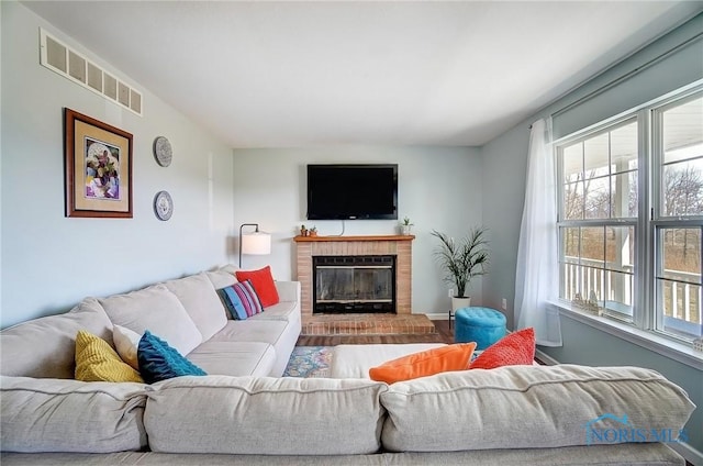 living room featuring a fireplace and visible vents