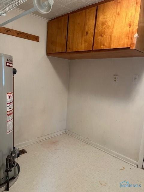 interior space with baseboards and gas water heater