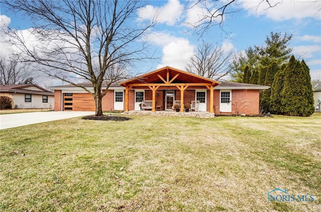 view of front of home featuring concrete driveway, brick siding, an attached garage, and a front lawn