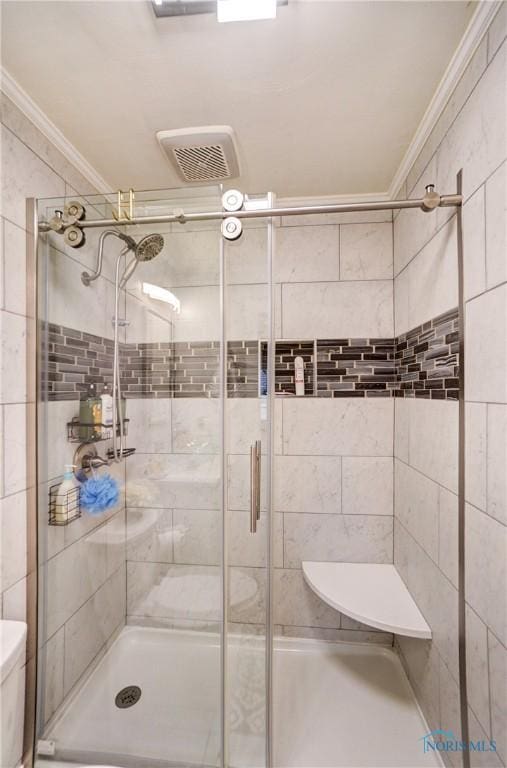 full bathroom with toilet, a shower stall, visible vents, and crown molding