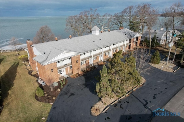 birds eye view of property with a water view